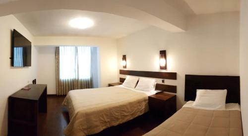 Postel nebo postele na pokoji v ubytování La Cabaña Hotel
