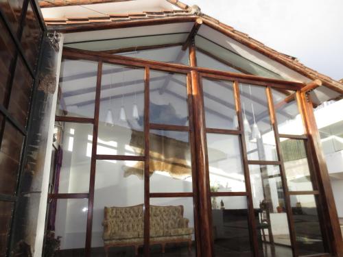 a glass window with a couch inside of it at La Cabaña Hotel in Cusco