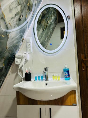 a bathroom with a sink and a mirror at Sunny House Buknari in Buknari