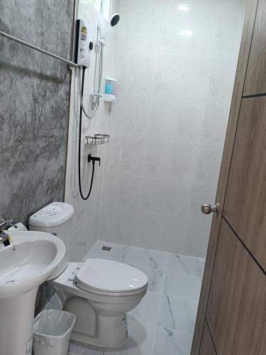 a bathroom with a shower and a toilet and a sink at Mumzai House 2 in Ko Muk