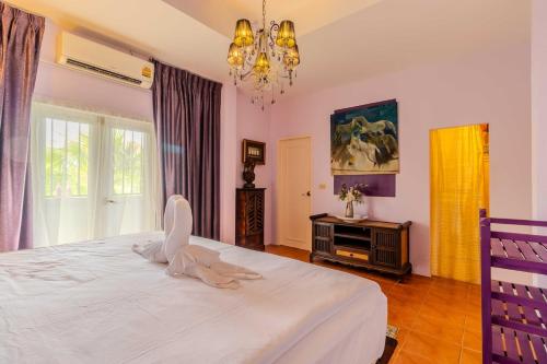 um quarto com uma grande cama branca e um lustre em V265 2BR Pool Villa Near Fitness Gyms Muay Thai em Ban Saiyuan (1)