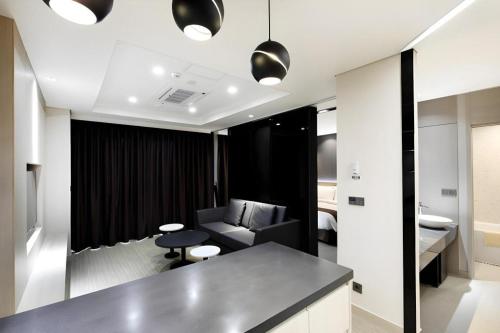 a living room with a couch and a table at Gloucester Hotel Kintex in Isan