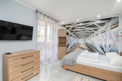a bedroom with a bed with a mural of a bridge at Charming Studio with Parking and Balcony in Karpacz by Noclegi Renters in Karpacz
