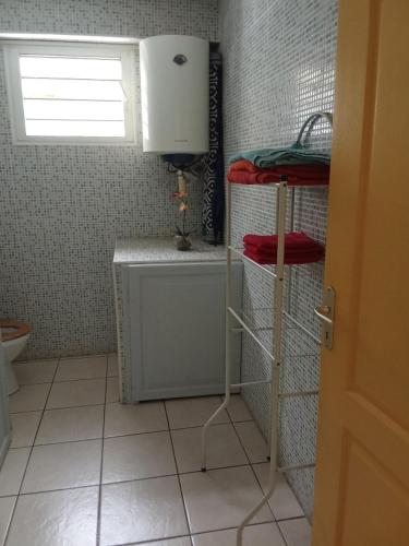 a small bathroom with a sink and a toilet at Residence Virginie in Saint-Leu