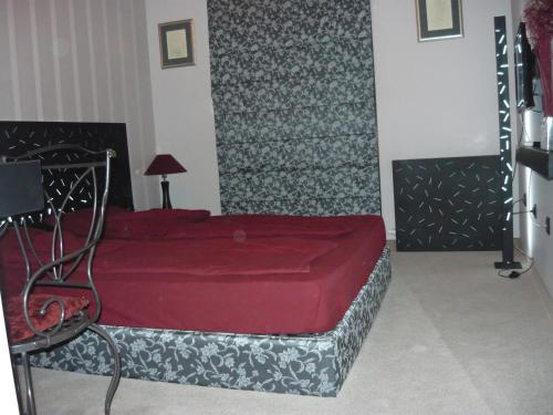 a bedroom with a red bed in a room at Vila 6aTo Hotel & Wellnes in Sofia