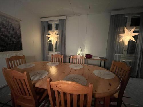 a dining room with a wooden table and chairs at Raanu Apartment 45 minutes from Rovaniemi center in Raanujärvi