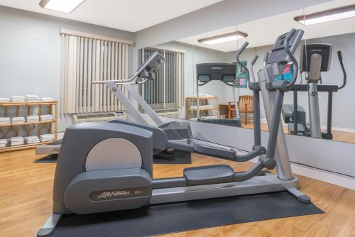 a gym with a treadmill in a room at Super 8 by Wyndham Bloomington/Airport in Bloomington
