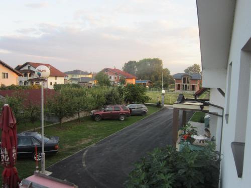 a view from the balcony of a house with parked cars at Pansion Laktaši in Laktaši