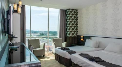 Postel nebo postele na pokoji v ubytování MH Hotels Ipoh