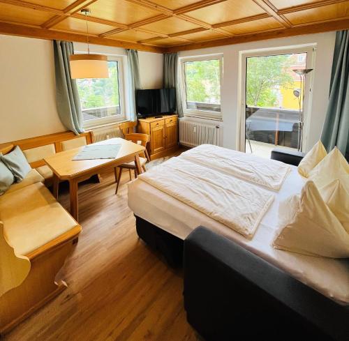 a bedroom with a bed and a table and a desk at Apartment Gastein 2 in Bad Gastein