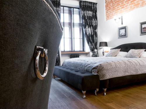 a bedroom with a bed and a couch and a window at Leonardo 2 in Kraków