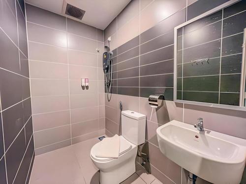 a bathroom with a toilet and a sink at TT Dorf Hotel (Taiping) in Taiping