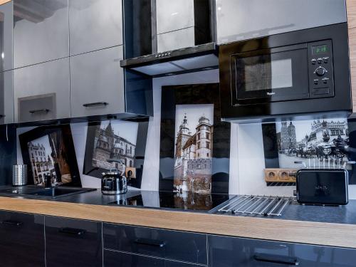 a kitchen with a counter top with a microwave at Leonardo 2 in Kraków