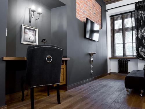 a dining room with a chair and a desk at Leonardo 2 in Krakow