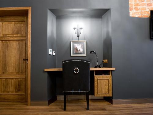 a black chair sitting at a table in a room at Leonardo 2 in Kraków