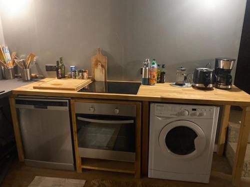 a kitchen with a counter with a sink and a dishwasher at Chalet coeur d'alpage La Plagne Les Arcs in La Plagne Tarentaise