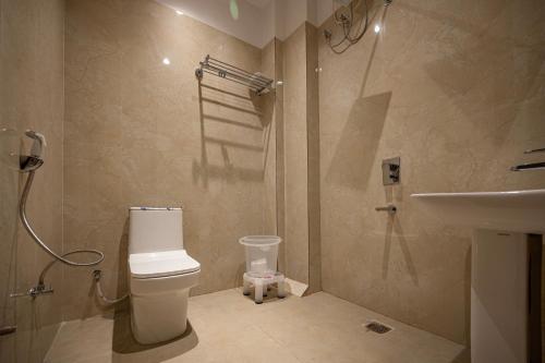 a bathroom with a toilet and a sink at swastik stays in Prayagraj