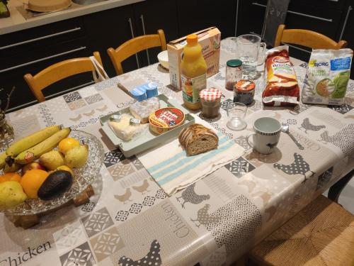 uma mesa com uma toalha de mesa com comida sobre ela em chambre dans une maison 