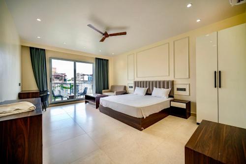 a hotel room with a bed and a balcony at swastik stays in Prayagraj