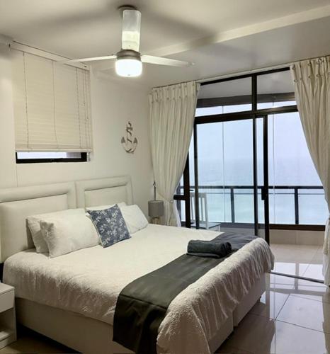 a bedroom with a bed with a view of the ocean at Coral Reef 502 in La Mercy