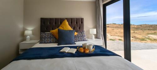 a bedroom with a bed with books and shoes on it at Black Eagle's Rest #Unit 1-8 in Langebaan