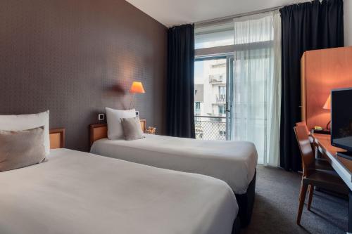 Ένα ή περισσότερα κρεβάτια σε δωμάτιο στο Hotel Des Lices