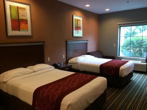 a hotel room with two beds and a window at The Inn in Monaca