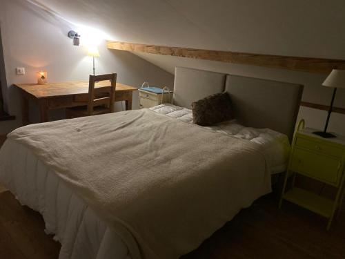 a bedroom with a white bed with a desk and a chair at Chalet coeur d'alpage La Plagne Les Arcs in La Plagne Tarentaise