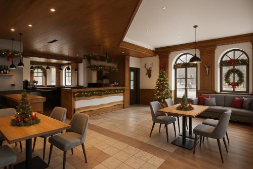 a living room with two tables and christmas trees at Golf Hotel Carezza in Carezza al Lago