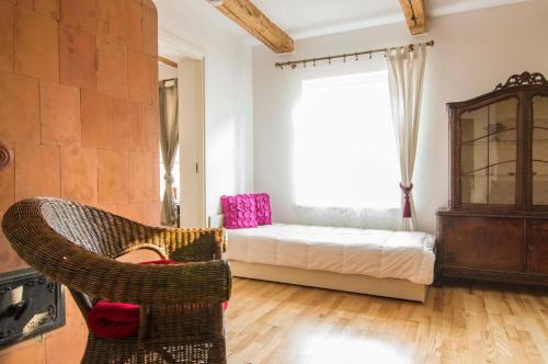 a bedroom with a bed and a chair and a window at Theodori Holiday House in Pärnu