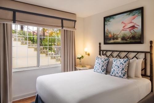 a bedroom with a large bed and a window at The Milo in Santa Barbara