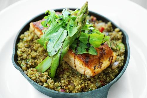 a bowl of food with meat and greens on top at Novotel Miami Brickell in Miami