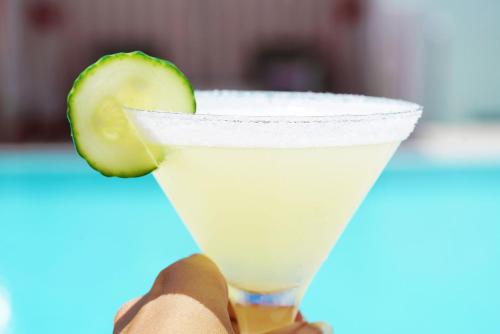 a person holding a margarita with a lime in a glass at Novotel Miami Brickell in Miami