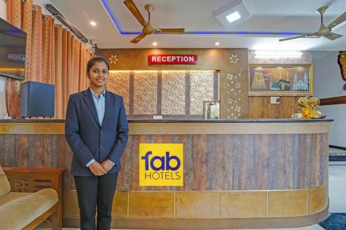 a woman standing in front of a hotel lobby at FabHotel Raja Residency in Alāndurai