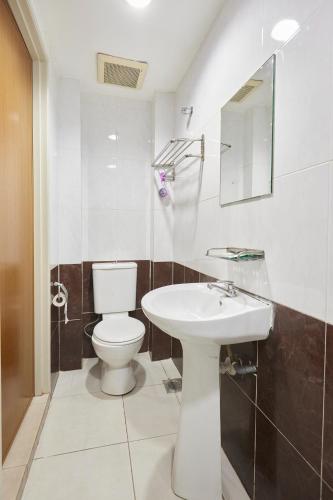 a bathroom with a toilet and a sink at Hotel Sunjoy9 OKR Near Midvalley 10 Mins Only in Kuala Lumpur