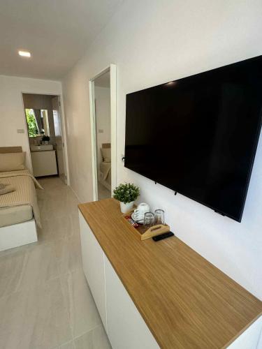 a living room with a large flat screen tv on a wall at SIAM LOUNGE - Pratumnak in Pattaya South