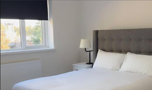 a bedroom with a white bed and a window at Welcome to Home away from home in Southampton