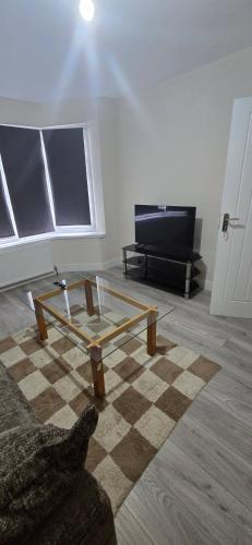 a living room with a coffee table and a tv at Welcome to Home away from home in Southampton