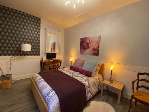 Voodi või voodid majutusasutuse Le Relais d'Angély toas