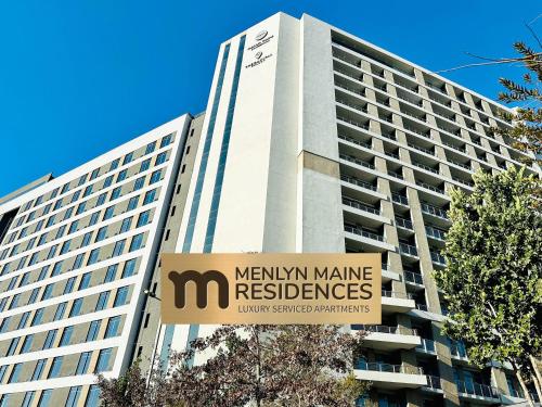 a large building with a sign in front of it at Menlyn Maine Residences - Kyoto king size xl bed in Pretoria