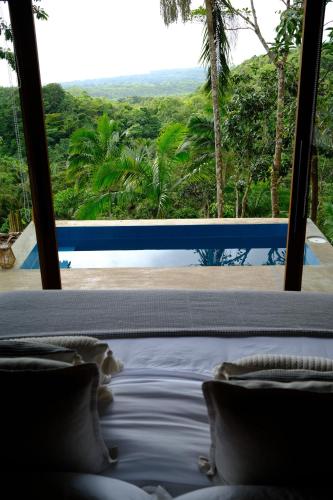 a view from a bedroom with a view of the ocean at Drako Villas- Adults only in Siquijor