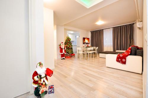a living room with a christmas tree and decorations at CityScape Bucharest in Bucharest