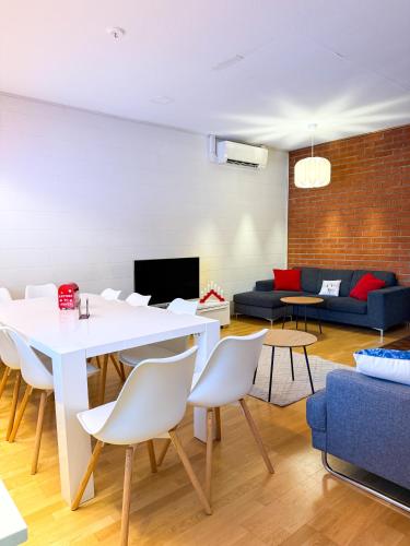 a living room with a white table and chairs at Large Group Fireside Cabin in Rovaniemi