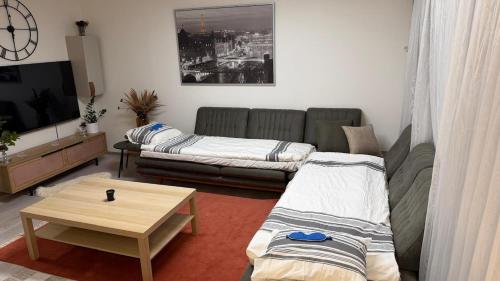 a living room with a couch and a coffee table at Private House with Sauna and Winter Garden in Helsinki