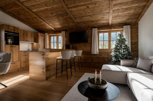 a living room with a couch and a table at Arnestgut in Strobl