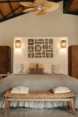 a bedroom with a bed with two pillows and a fan at Hunza Longevity Resort in Eskiömerler
