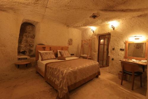 En eller flere senge i et værelse på Gazel Cave House