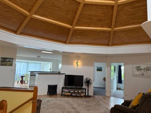 a living room with a wooden ceiling at Hinterland Grandeur Retreat Tamborine Mountain in Mount Tamborine