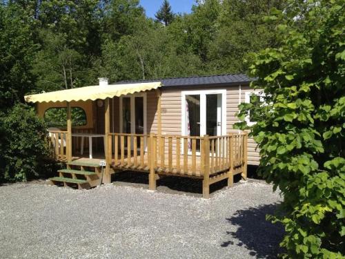 a cabin with a porch and a gazebo at Camping 3 étoiles - Piscine - eehhec in Landry