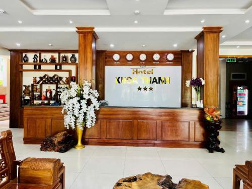 a lobby with a large screen and flowers in a vase at Khoa Thanh Hotel in Mai Chau